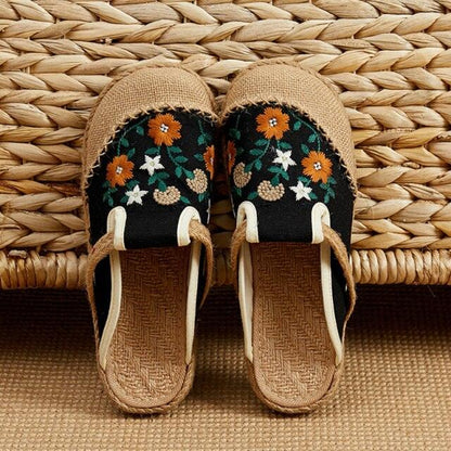 Pair of Stevvex linen mules with floral embroidery on black canvas upper beige jute soles on Tampa Home & Garden Store