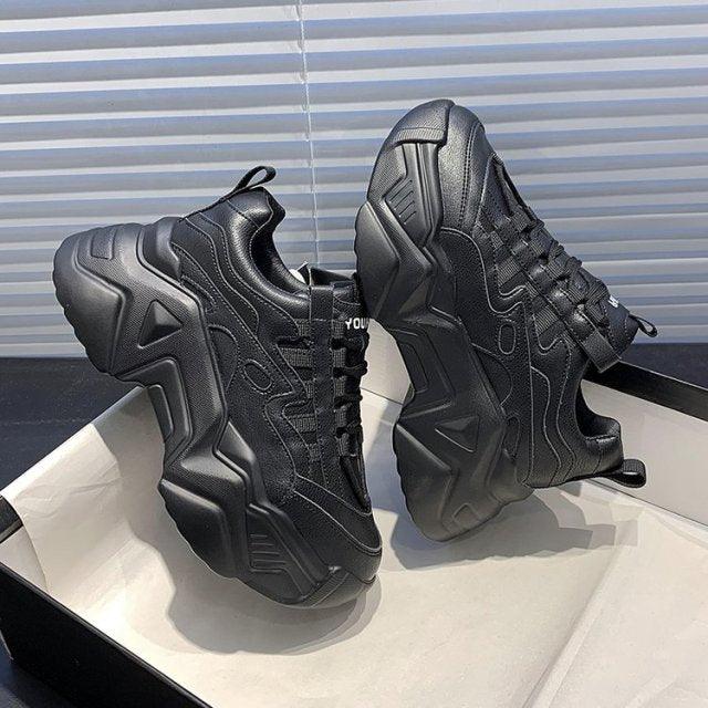 Pair of women black chunky platform sneakers with lace-up and thick sole on Tampa Home & Garden Store