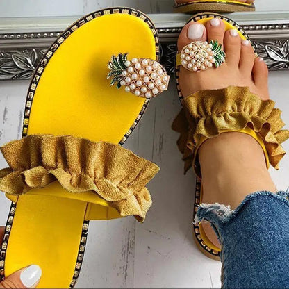 Pair of women's yellow flat Stevvex sandals with pineapple pearl ornament and gold ruffle strap on Tampa Home & Garden Store