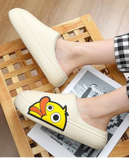 Slippers pair: cream EVA closed-toe slip-ons with yellow duck graphic and thick platform sole on Tampa Home & Garden Store