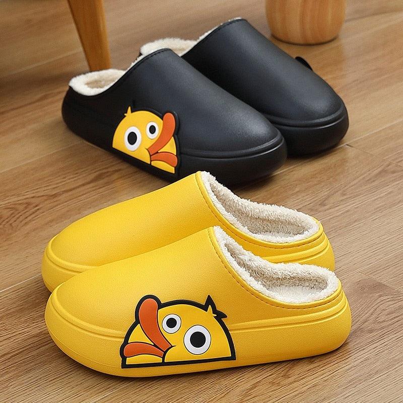 Slippers Stevvex yellow fleece-lined with cartoon duck graphic; black pair behind, 2 pairs total on Tampa Home & Garden Store