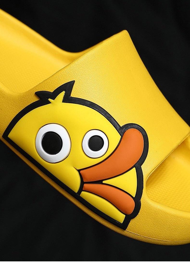 Yellow EVA open-toe slide with a large cartoon duck face, bold black outline, thick sole on Tampa Home & Garden Store