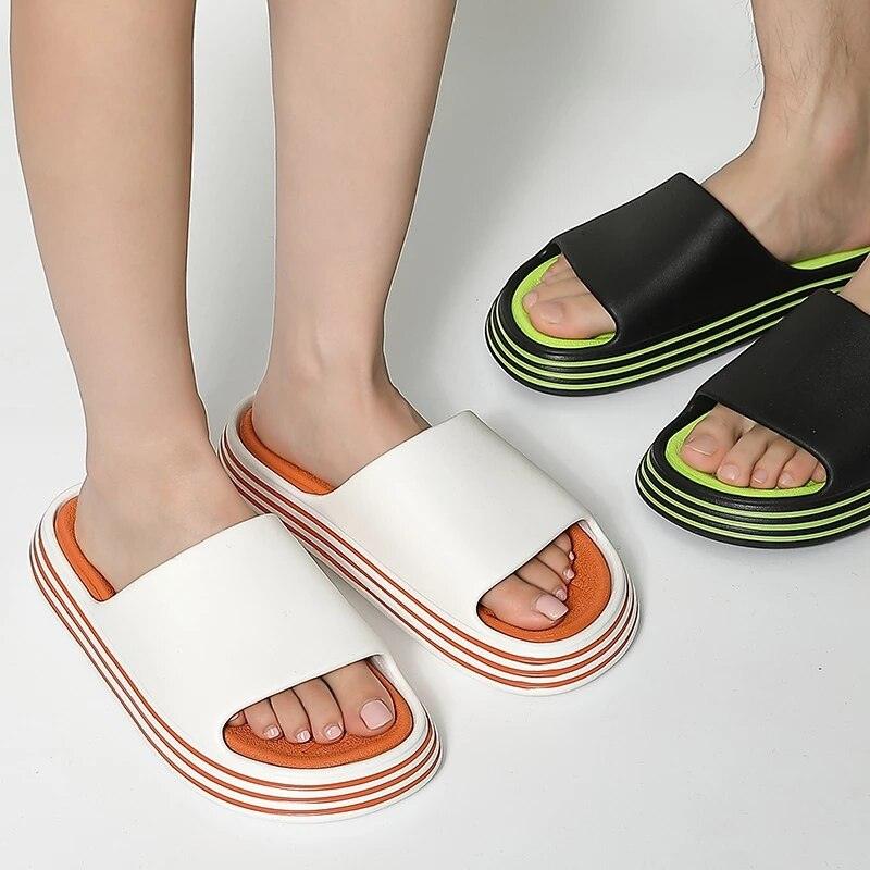 White EVA slide sandals with orange inner and striped sole; black neon-green slides open toe on Tampa Home & Garden Store