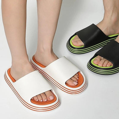 White EVA slide sandals with orange inner and striped sole; black neon-green slides open toe on Tampa Home & Garden Store