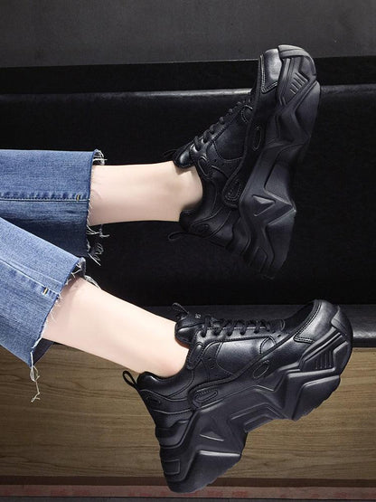 Pair of women black leather platform sneakers with chunky sole and lace-up for casual wear on Tampa Home & Garden Store
