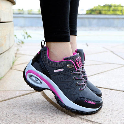 Women running air cushion athletic sneakers with black gray mesh upper and pink accents on Tampa Home & Garden Store