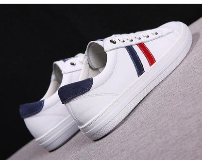 Women's white genuine leather sneakers with navy suede heel and blue/red side stripes on Tampa Home & Garden Store