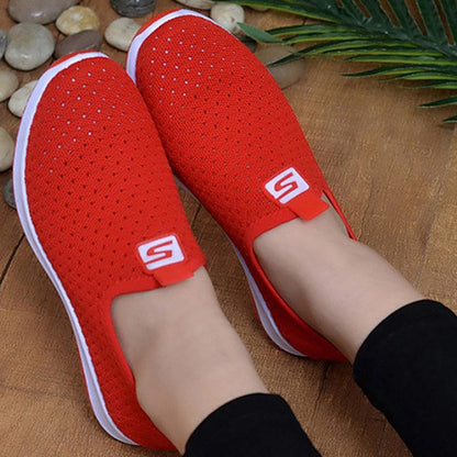 Stevvex pair of women's slip-on sneakers with red breathable mesh upper and white sole, S logo tab on Tampa Home & Garden Store