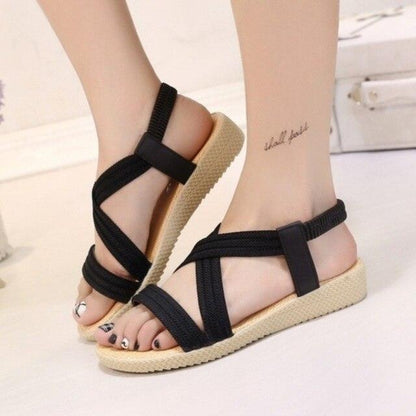 Pair of black Stevvex women sandals with elastic ankle straps and beige textured sole on Tampa Home & Garden Store