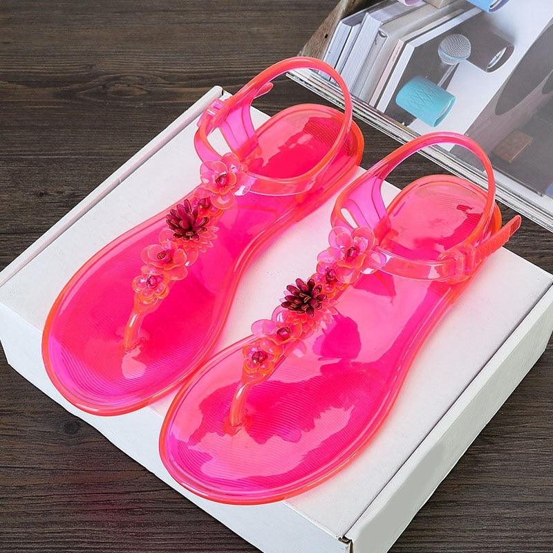Pink jelly sandals pair Stevvex with floral T-strap, translucent beach slides on Tampa Home & Garden Store