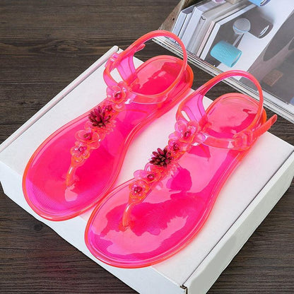 Pink jelly sandals pair Stevvex with floral T-strap, translucent beach slides on Tampa Home & Garden Store