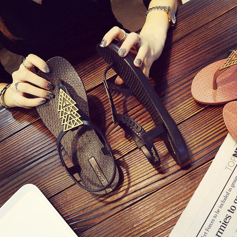 Women's sandals by Stevvex: black T-strap flat with gold ornament, beige flip flop on table on Tampa Home & Garden Store
