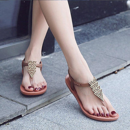 Women Stevvex tan T-strap flat sandals with geometric gold pendant on Tampa Home & Garden Store