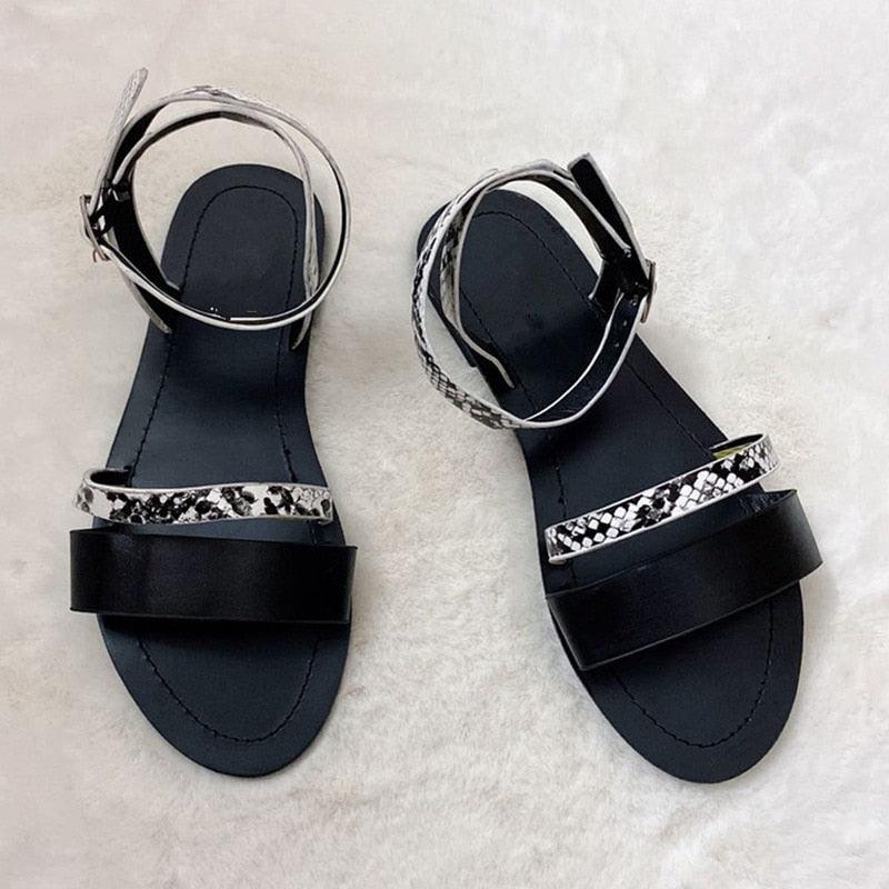 Pair of Stevvex black women's sandals with open toe, patterned strap and adjustable ankle wrap on Tampa Home & Garden Store