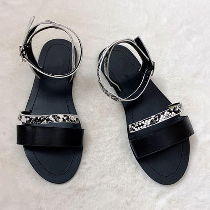 Pair of Stevvex black women's sandals with open toe, patterned strap and adjustable ankle wrap on Tampa Home & Garden Store