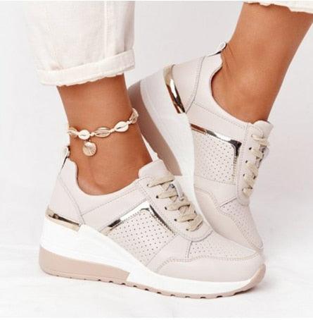 Women's cream lace-up sneakers with perforated panels and gold heel accents on a wedge sole on Tampa Home & Garden Store