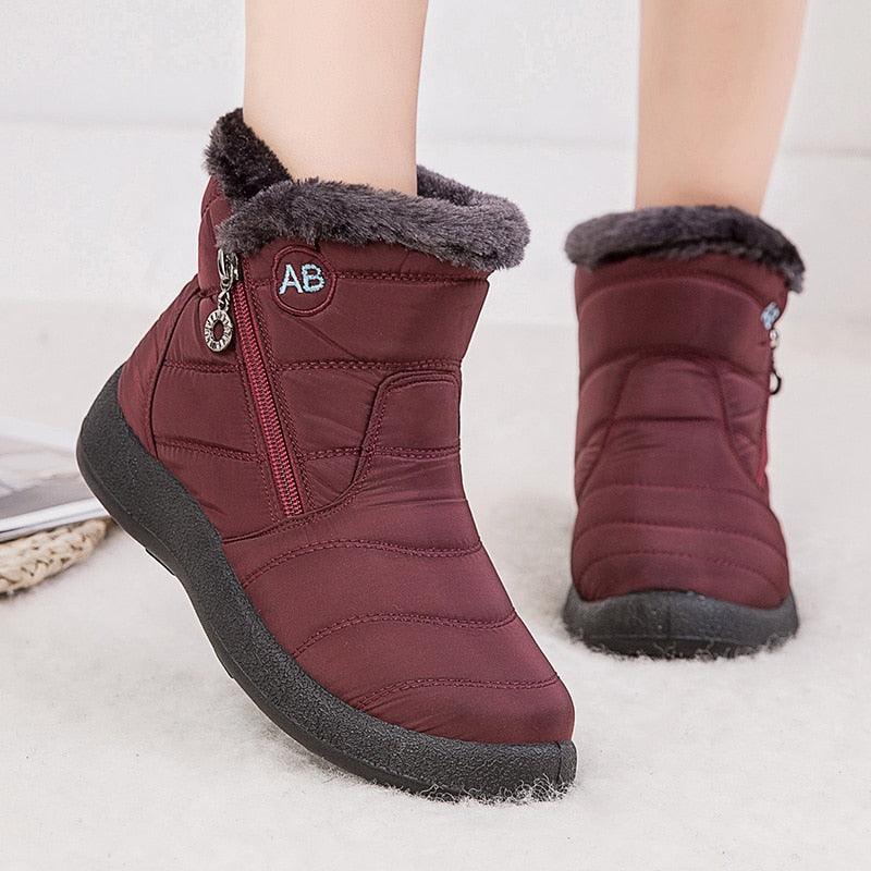 Pair of burgundy Stevvex fur-lined ankle snow boots with side zip and fuzzy cuff on Tampa Home & Garden Store