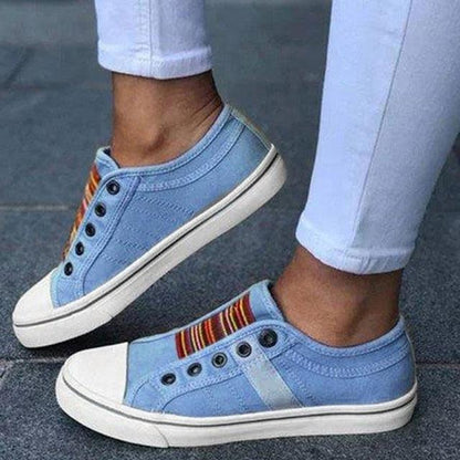 Pair of light blue canvas sneakers with white toe caps and white soles, low-cut casual flats on Tampa Home & Garden Store