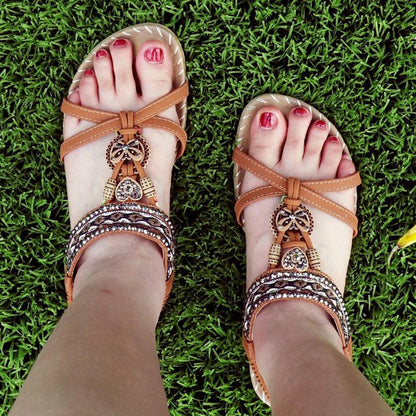 Stevvex butterfly-knot rhinestone sandals pair with elastic ankle straps in tan brown on grass on Tampa Home & Garden Store