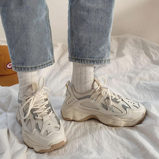 Pair of cream-white mesh chunky sneakers with thick sole and lace-up design, worn with socks on Tampa Home & Garden Store
