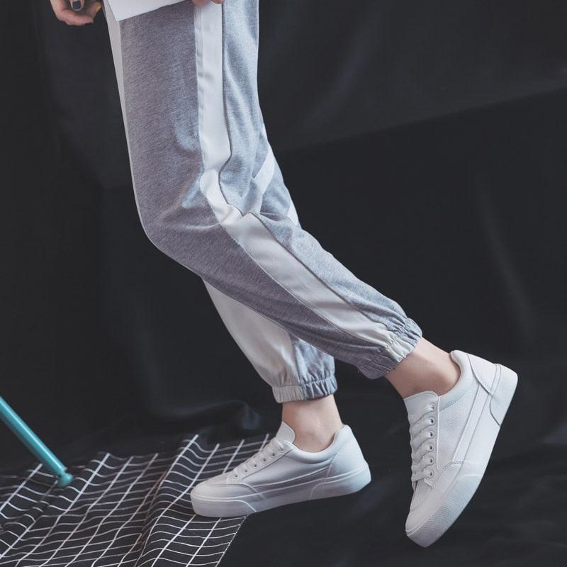 Women white Stevvex sneakers with lace-up closure and platform sole, shown with gray joggers on Tampa Home & Garden Store