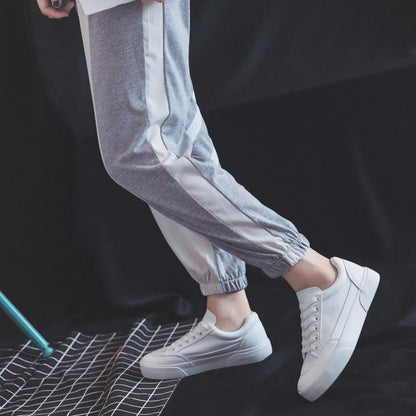 Women white Stevvex sneakers with lace-up closure and platform sole, shown with gray joggers on Tampa Home & Garden Store