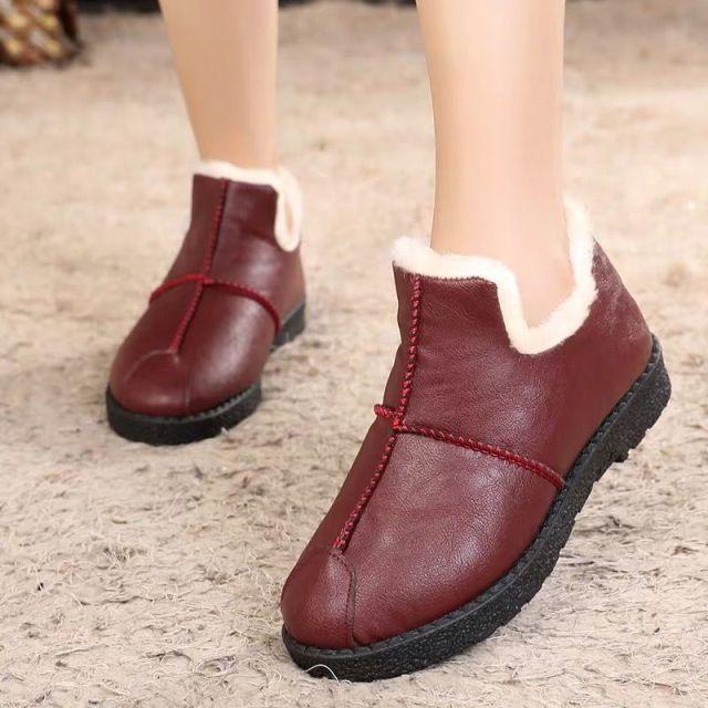 Pair of burgundy Stevvex leather winter boots with white plush fur lining and black sole on Tampa Home & Garden Store