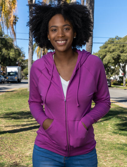 Women's Spun Bamboo Zip Hoodie in purple, bamboo French Terry fabric, worn by a smiling woman outdoors on Tampa Home & Garden Store