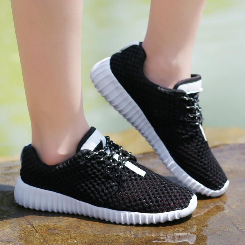 Pair of Stevvex women's mesh casual sneakers with black knit upper and white ribbed sole on Tampa Home & Garden Store