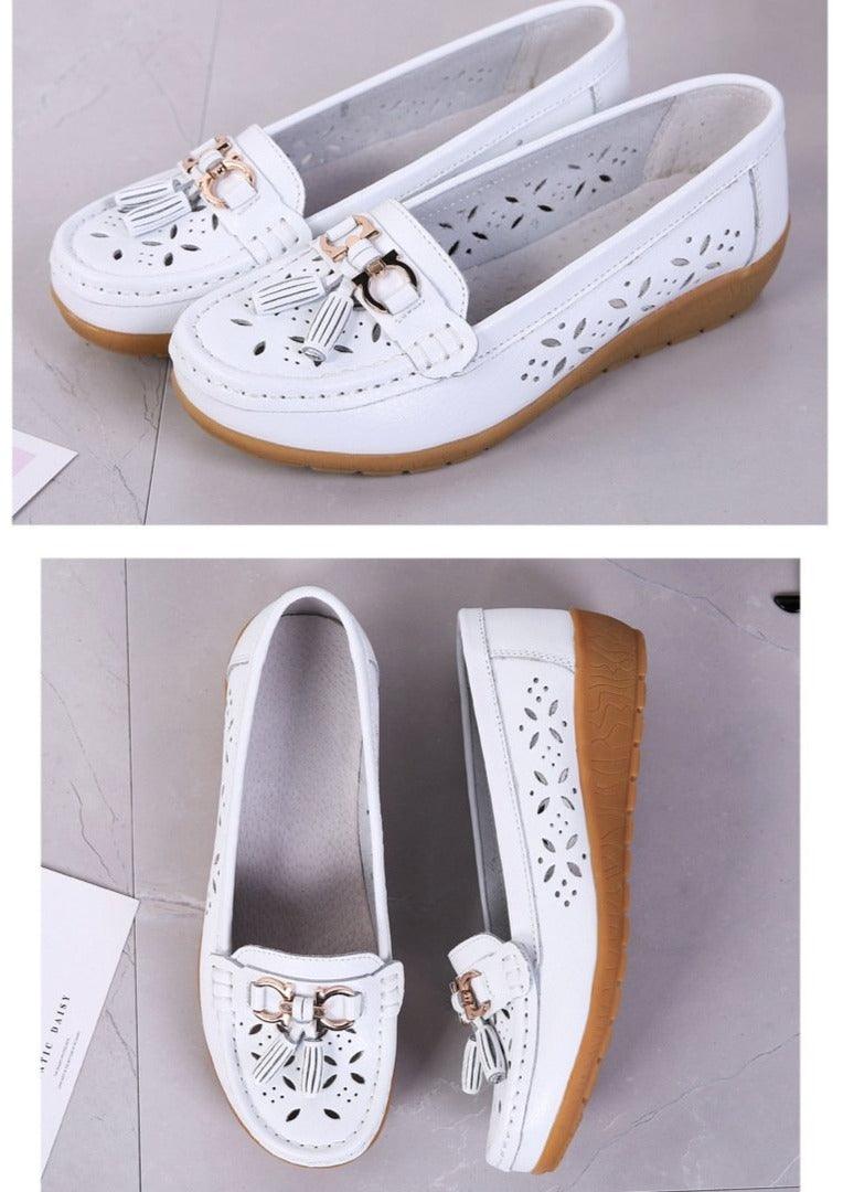 Stevvex white women's slip-on flats with floral cutouts and tassel buckle detail, tan sole on Tampa Home & Garden Store