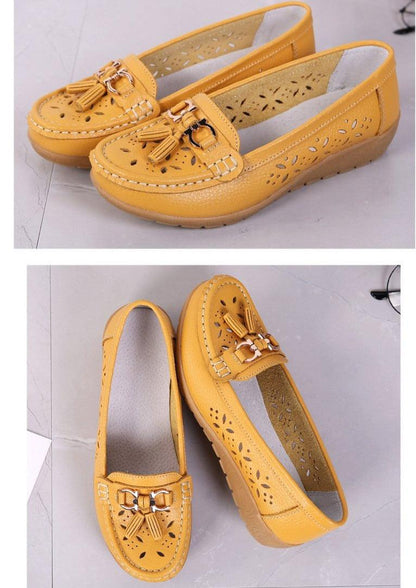 Womens pair of flats Stevvex yellow leather slip-ons with tassel buckles and floral cutouts on Tampa Home & Garden Store