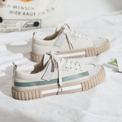 Pair of Stevvex canvas sneakers in cream with green stripe and tan sole on Tampa Home & Garden Store