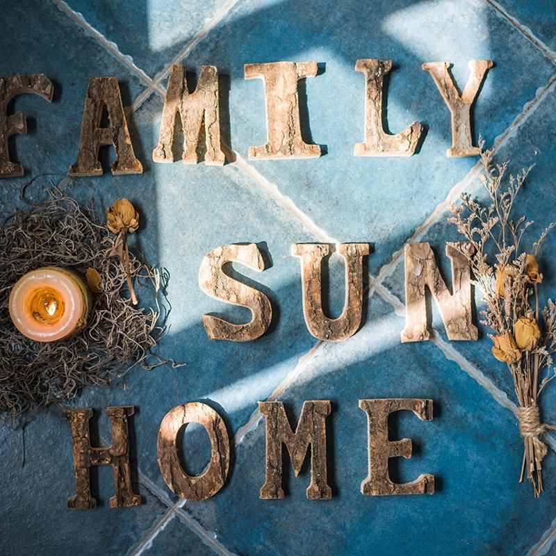 RusticReach alphabet letters FAMILY SUN HOME on blue floor with candle and dried botanicals on Tampa Home & Garden Store