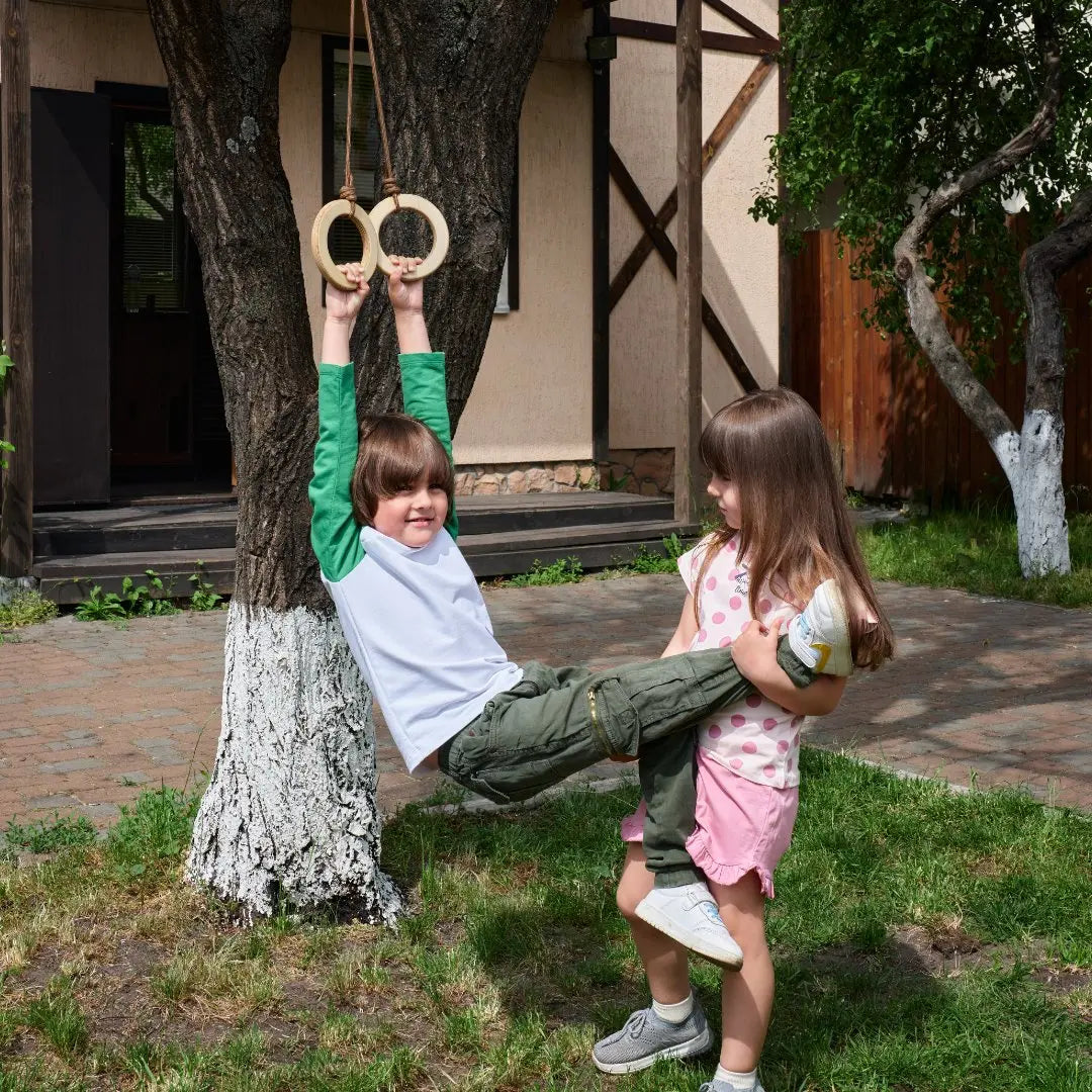 Goodevas wooden gymnastic rings for kids single swing, two wooden rings shown outdoors on Tampa Home & Garden Store