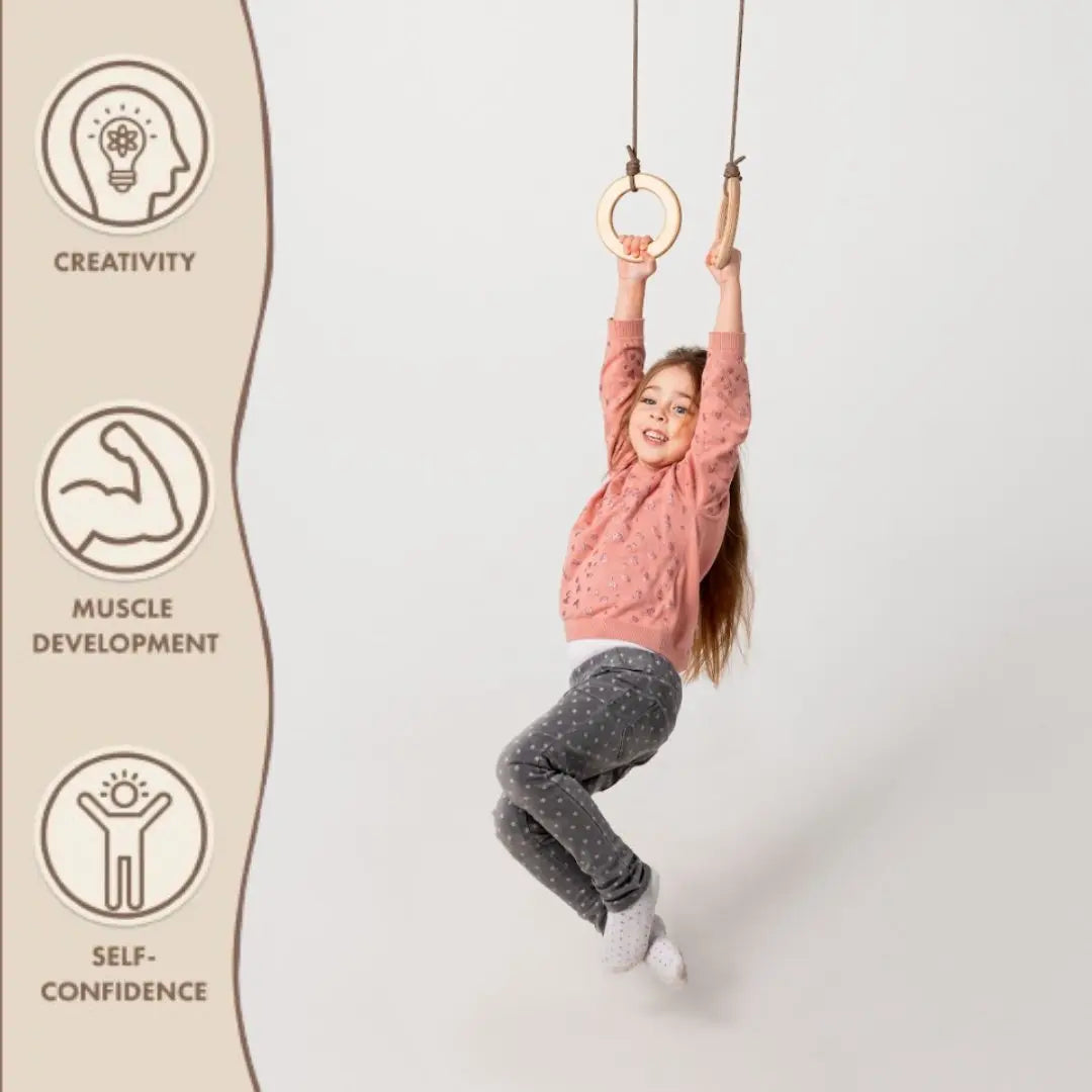 Wooden gymnastic rings single swing with hanging cords; child in pink sweater swinging on Tampa Home & Garden Store