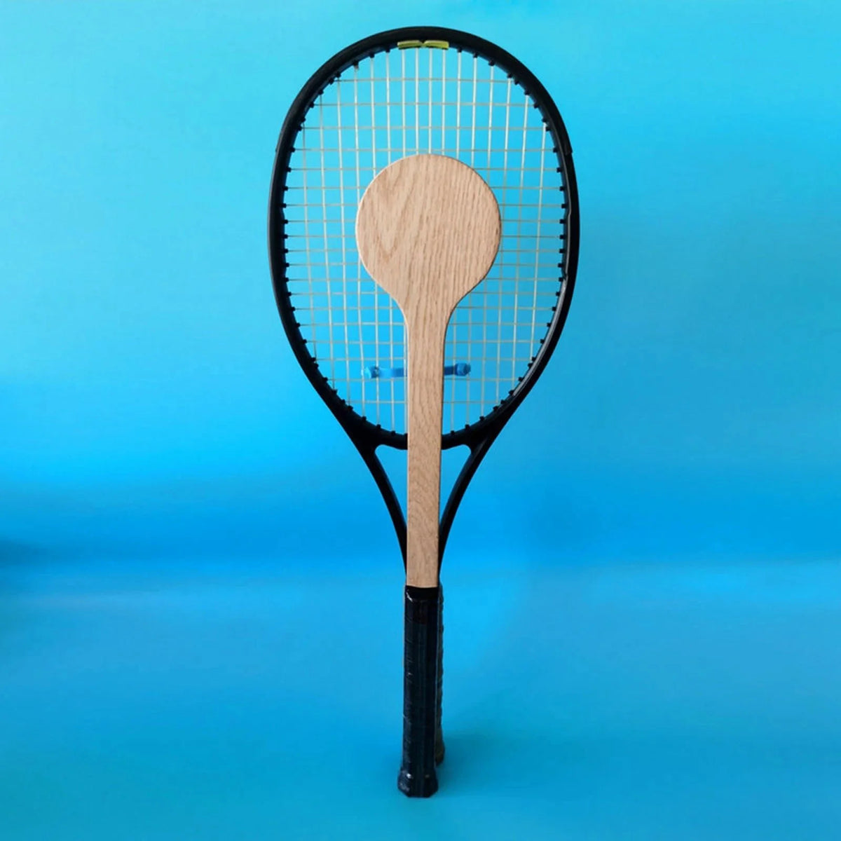 Tennis swing trainer with wooden spoon positioned in the racket strings EstaliosFit on Tampa Home & Garden Store