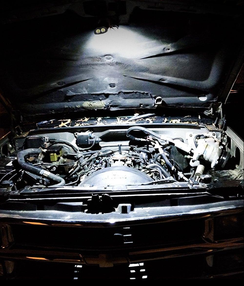 Stevvex black rechargeable LED work light illuminating a car engine bay under the hood on Tampa Home & Garden Store