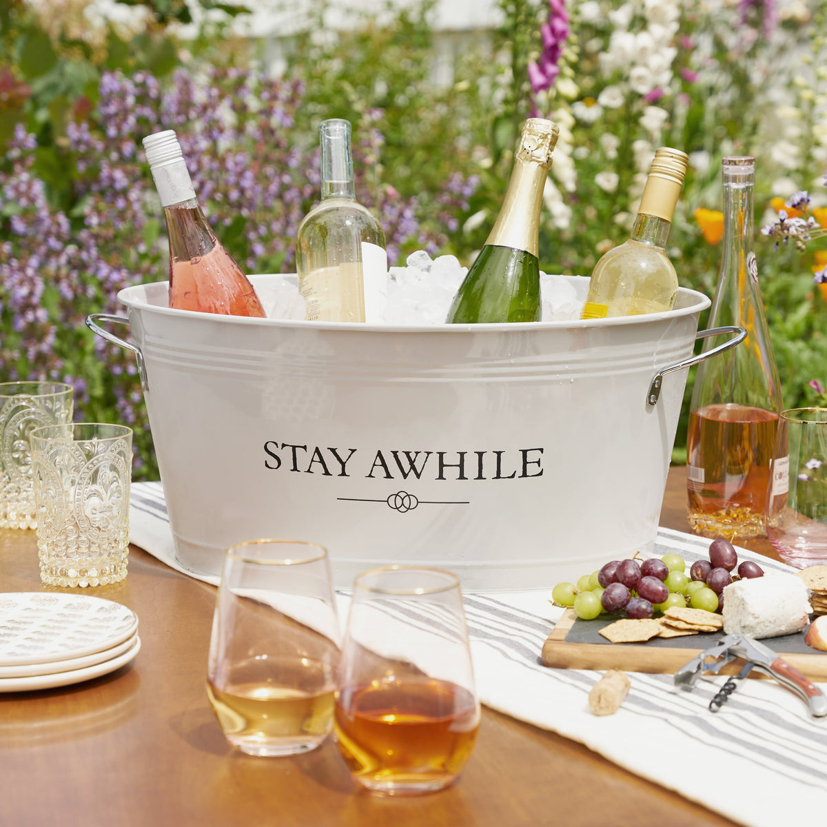 Stay Awhile white metal drink tub ice bucket with four wine bottles in ice Twine Living on Tampa Home & Garden Store
