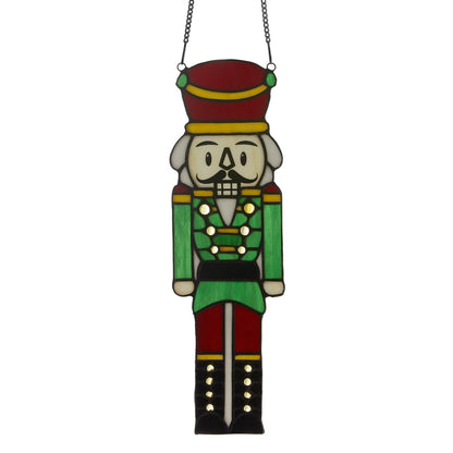 Hans the Holiday Nutcracker stained glass window panel with green uniform and red hat on Tampa Home & Garden Store
