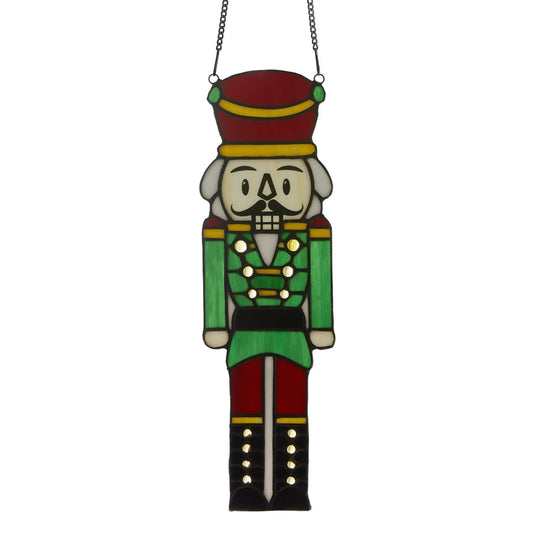 Hans the Holiday Nutcracker stained glass window panel with green uniform and red hat on Tampa Home & Garden Store