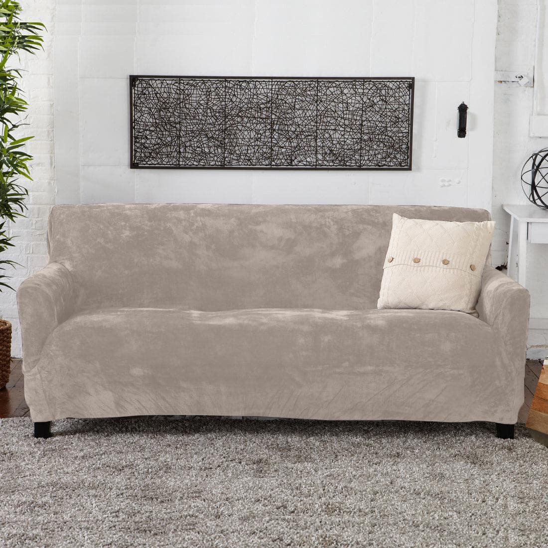 Velvet Stretch Slipcover Gale Collection in taupe on sofa with cream pillow on Tampa Home & Garden Store