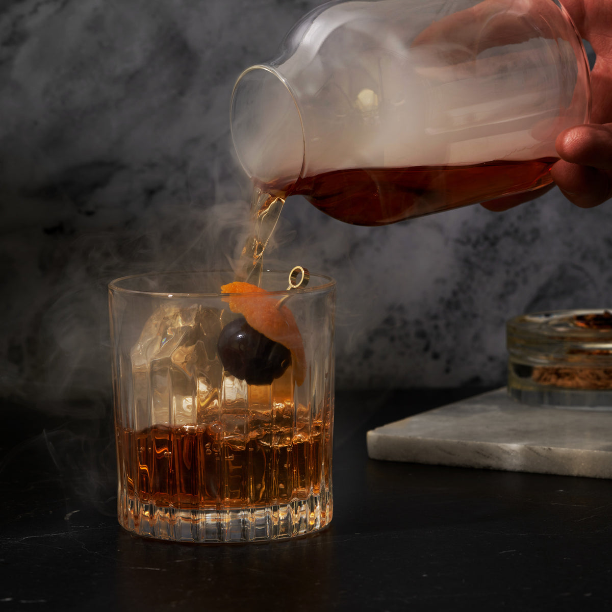 5 Piece Stacking Smoked Cocktail Kit Viski, amber cocktail poured into a faceted glass on Tampa Home & Garden Store
