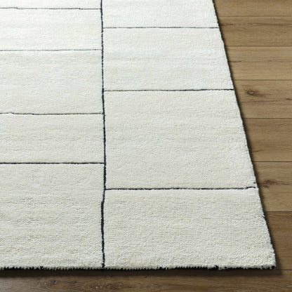 Xylia Ivory Area Rug by Boutique Rugs with ivory color and black grid pattern on wood floor on Tampa Home & Garden Store