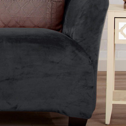 Velvet Stretch Slipcover Gale Collection by Great Bay Home in dark charcoal on a sofa with a textured rust cushion on Tampa Home & Garden Store