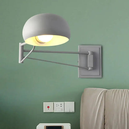 Yellow adjustable metal wall sconce with bowl shade by Decorbites for bedroom on green wall on Tampa Home & Garden Store
