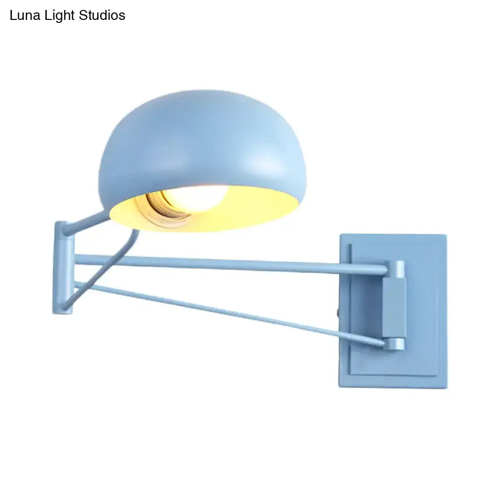 Blue metal wall sconce with yellow interior bowl shade and adjustable arms for bedroom on Tampa Home & Garden Store