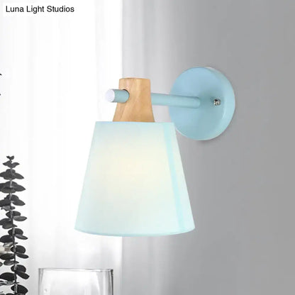 Macaron fabric wall light sconce with wood accent and pastel blue shade on Tampa Home & Garden Store