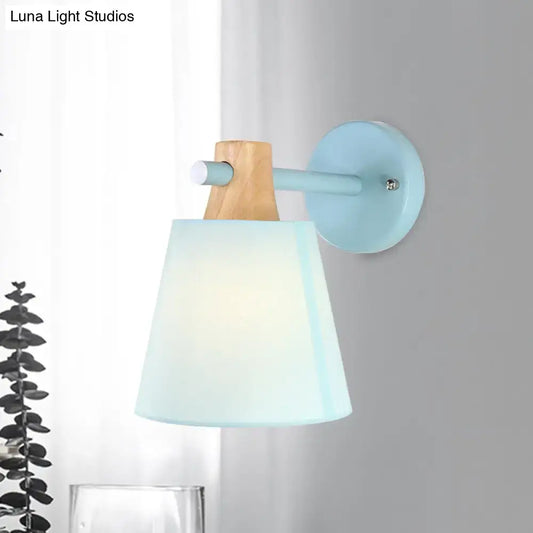 Macaron fabric wall light sconce with wood accent and pastel blue shade on Tampa Home & Garden Store