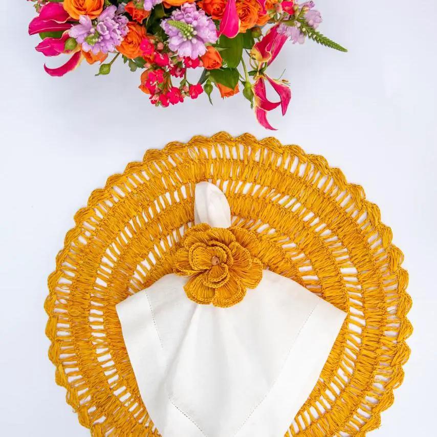 Buriti straw placemats by Talah Home, handcrafted golden yellow round woven mat with napkin on Tampa Home & Garden Store