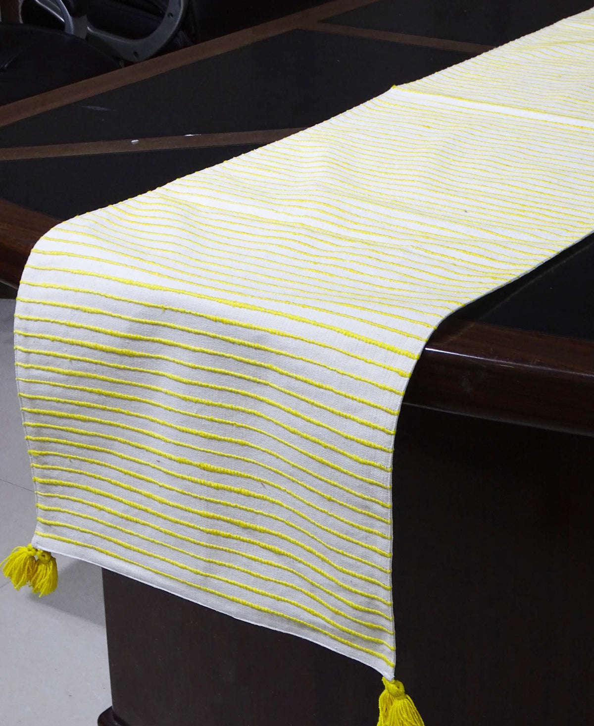 Vibhsa cotton table runner with yellow stripes, 16x90, tassels at ends on dark dining table on Tampa Home & Garden Store